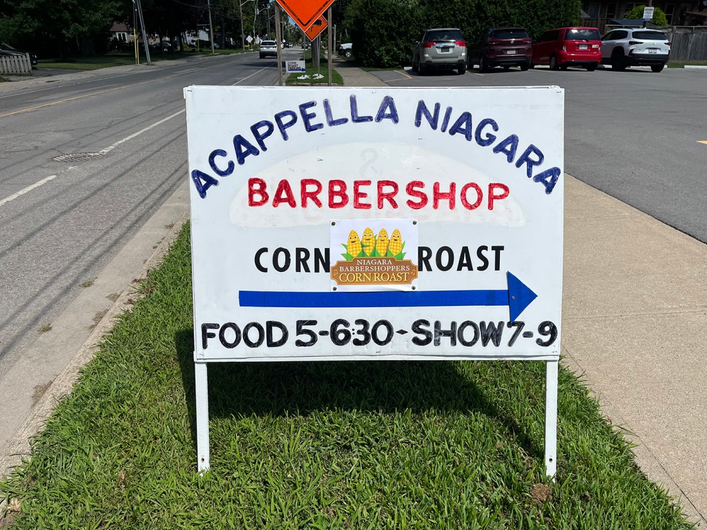 Sign for corn roast and A Cappella Niagara